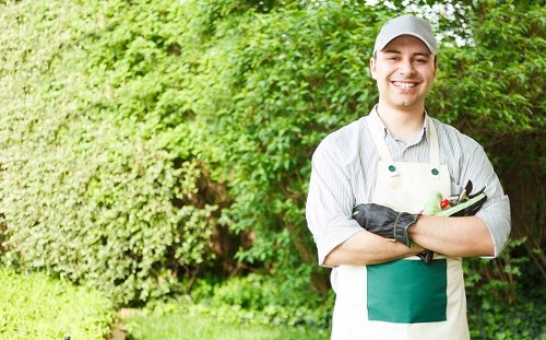 Landscaper wearing PPE while working in a Canary Wharf garden